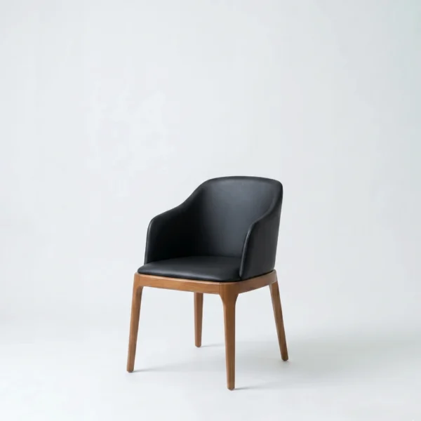 Zenish dining chair barrel-style accent chair with sleek black upholstery in a bright studio layout.