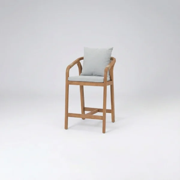Alta luxury outdoor bar chair in premium teak featuring a compact footprint, curved arms, and plush cushions.